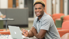 Student sitting at computer facing front